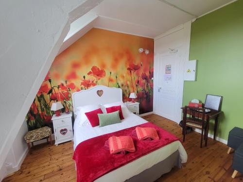 a bedroom with a large bed with a painting on the wall at Château de Surville in Surville