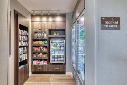a grocery store aisle with a refrigerator and drinks at Residence Inn by Marriott Providence Lincoln in Lincoln