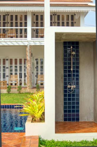 a building with a pool in front of it at Chic stay HANA Boutique hotel in Luang Prabang