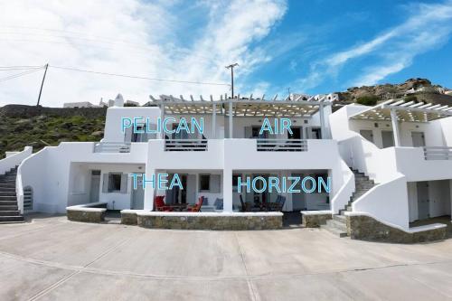 a white building with the words pelican art the a horon at 1Path Pelican Mykonos Super Paradise Beach House in Mýkonos City