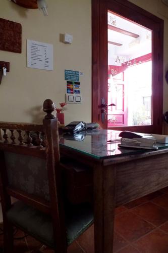 an office with a wooden desk and a window at Hotel Rural Posada Los Caballeros in Almagro