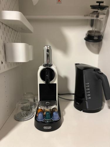 a black and white blender sitting on a counter at H-Apartments in Trier