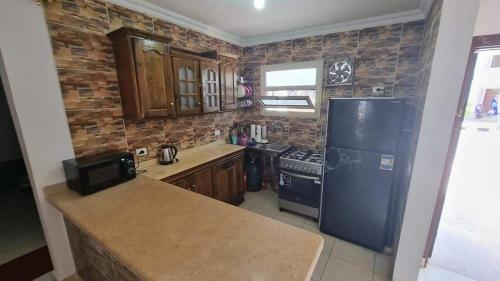 a kitchen with a refrigerator and a counter top at شيماء كسل in Cairo