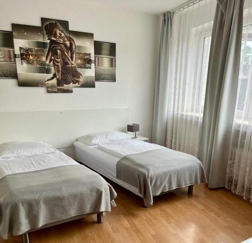 a bedroom with two beds and a window at Old Town View in Cologne