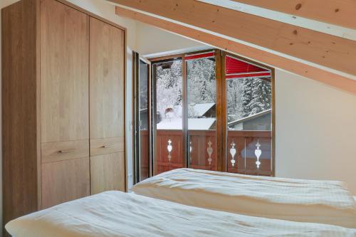 a bedroom with a bed and a window at Ferienwohnung Partnachklamm in Garmisch-Partenkirchen