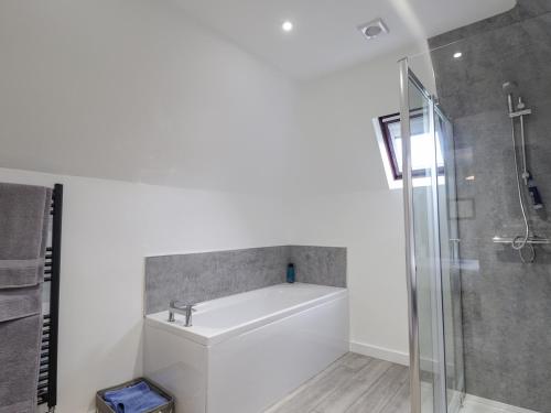 a bathroom with a shower and a bath tub at Fresh Fields in Dingwall