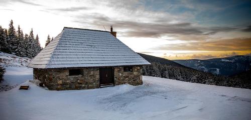 a small cabin in the snow on a mountain at Turistická chata Švýcarna in Loučná nad Desnou