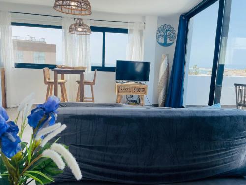 a living room with a large bed and a tv at Casa Iris El Cotillo in Cotillo