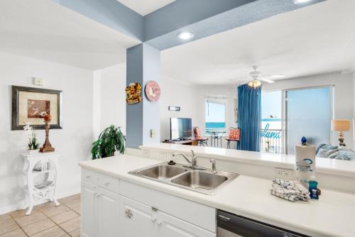 a kitchen with a sink and a view of the ocean at Destin West Gulfside #608 in Fort Walton Beach