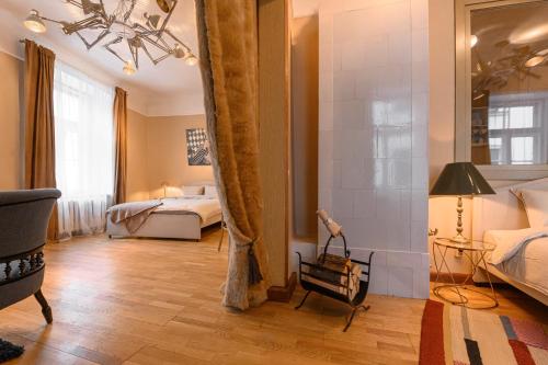 a bedroom with two beds and a large window at St.Jacobs's apartments Old Town Riga in Rīga