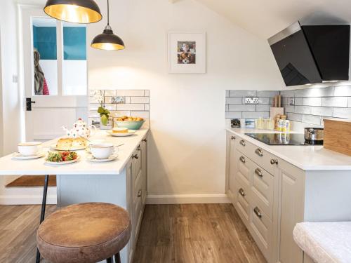 a kitchen with a table with food on it at Longlands Farm Cottage in Grange Over Sands