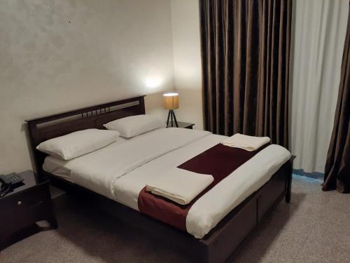 a bedroom with a large bed in a room at Tamrah Suites Hotel in Amman