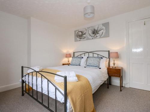 a bedroom with a bed and a bedside table at Fieldview Cottage in Great Massingham