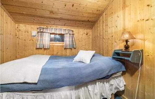 a bedroom with a bed in a wooden room at Stunning Home In Eggedal With Kitchen in Eggedal