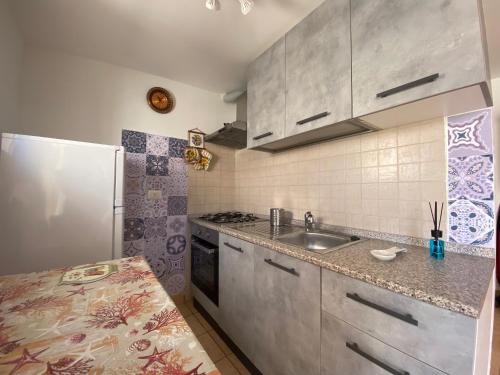 a kitchen with a sink and a refrigerator at DeA Studio in Anzio