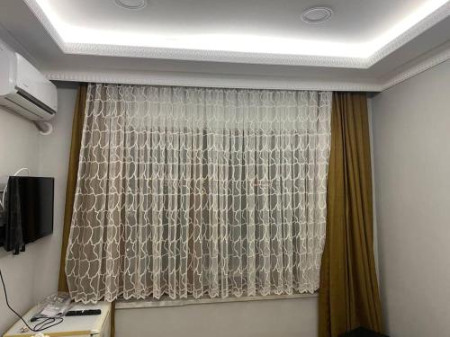 a room with a window with a curtain at A Beachfront, Peninsula View Apartment in Karaköy in Istanbul