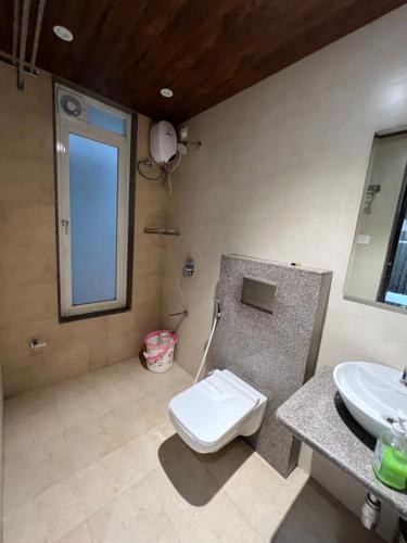 a bathroom with a toilet and a sink at CAPETOWN VILLAS (MOUNTAIN VIEW) in Igatpuri