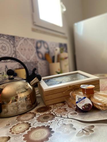 a tea kettle and a box on a kitchen counter at DeA Studio in Anzio