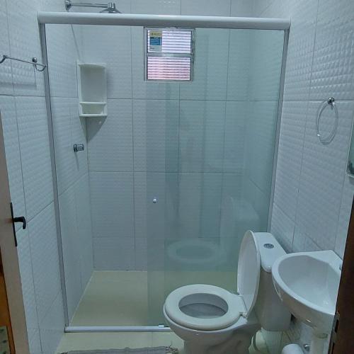a bathroom with a shower and a toilet and a sink at Casa com picina in São José da Coroa Grande