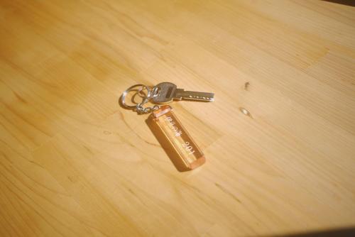 a key chain sitting on a wooden table at Izu-no-umi Hotel in Atami