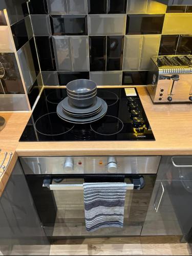 a kitchen with a stove with a pot on it at Modern flat in Maidstone in Kent