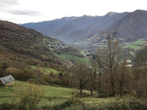a view of a valley with trees and mountains at Happy HOME in Cierp