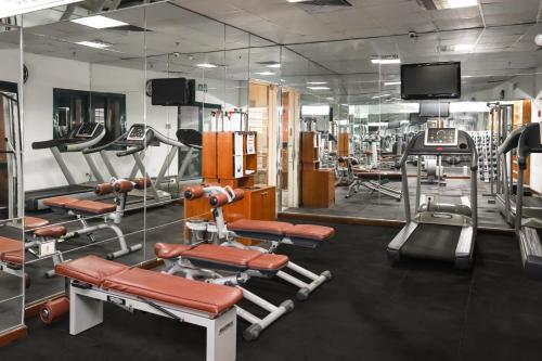 a gym with several tread machines and a tv at Sharm Dreams Vacation Club - Aqua Park in Sharm El Sheikh