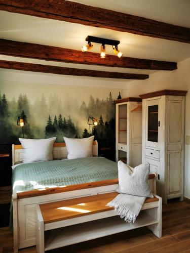 a bedroom with a bed with a painting on the wall at Haselnuss in Ilsenburg