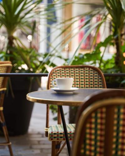 a coffee cup sitting on top of a table at Hôtel du Sentier in Paris