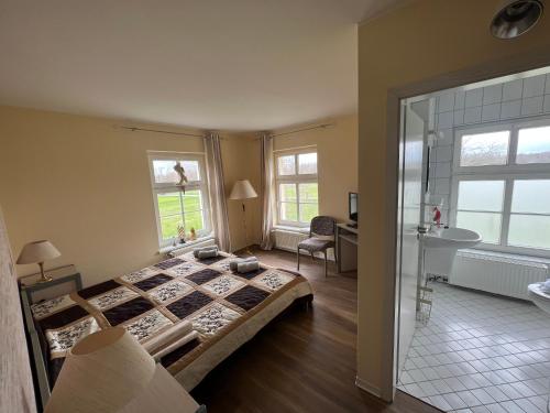 1 dormitorio con 1 cama grande y baño en Spreewaldhotel Leipe, en Leipe