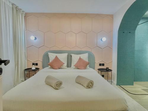 a bedroom with a large bed with two pillows at Les 3 arches - Grenoble in Grenoble
