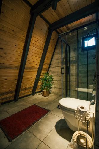 a bathroom with a glass shower and a toilet at KARMATTE BUNGALOW in Kartepe