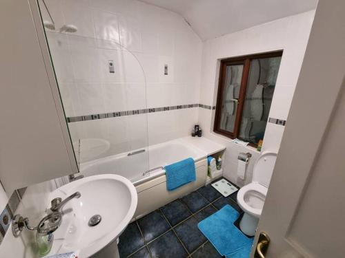 a bathroom with a tub and a sink and a toilet at Entire house with parking, centrally located & close to Aviva Stadium in Dublin