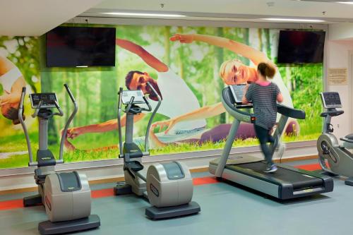 a man riding on a treadmill in a gym at Ghent Marriott Hotel in Ghent