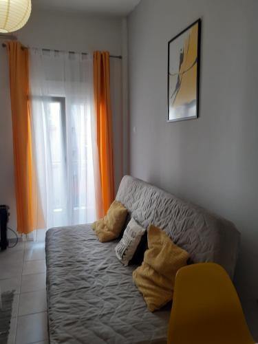 a living room with a couch and a window at Central City Kristalli studio in Thessaloniki