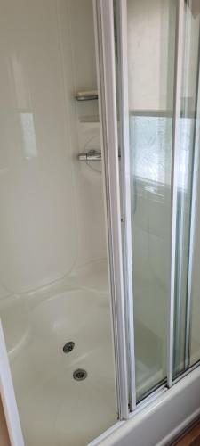 a shower with a glass door in a bathroom at Wrights Retreat 4 Lunan View St Cyrus Caravan Park in Saint Cyrus