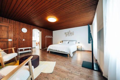a bedroom with a bed and a wooden ceiling at theNest Glarus Studio-Apartment in Glarus