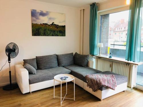 a living room with a couch and a window at Zentrale Studio Wohnung in Emden in Emden