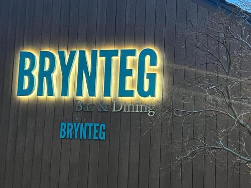 a neon sign on the side of a building at Number 57 Brynteg in Caernarfon
