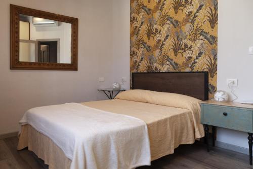 a bedroom with a bed with a mirror and a dresser at SantaBarbara in Meleto