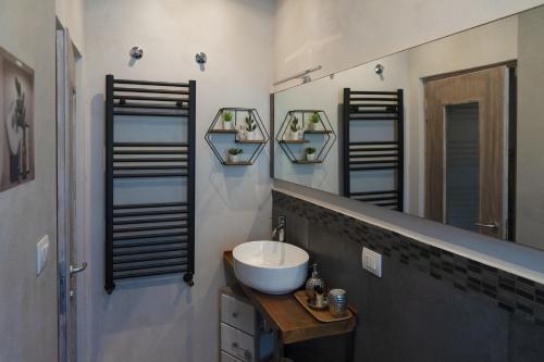 a bathroom with a sink and three mirrors at SantaBarbara in Meleto