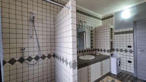 a bathroom with a sink and a toilet and a mirror at Hollywood Apartment in Capoliveri