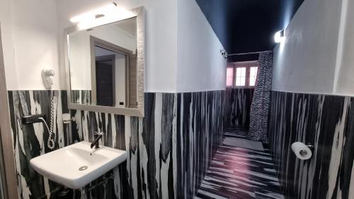 a bathroom with a sink and a mirror at Diaboliko Apartment in Capoliveri