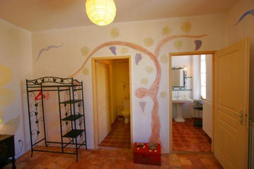 a room with a wall with a tree painted on it at Le Relais de Tamaroque in Portel-des-Corbières