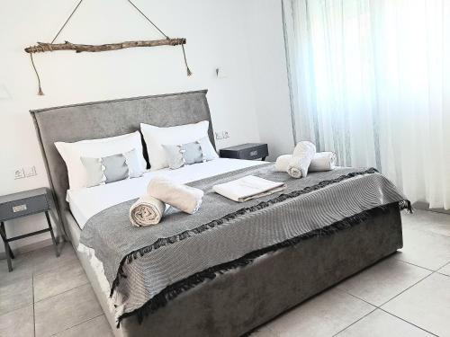 a bedroom with a large bed with towels on it at Petrino Studios in Keramotí