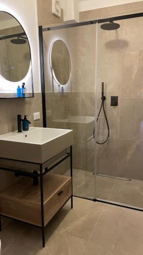 a bathroom with a sink and a shower at Coriva Homes Termenago in Pellizzano