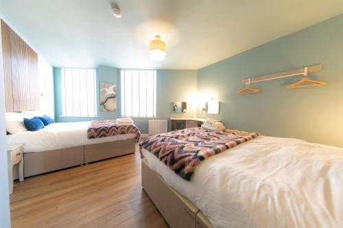a large bedroom with two beds in it at The Old Bank Apartments in Blackpool