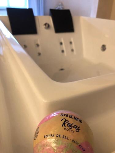 a bath tub with a sink with a sticker on it at Allegra Toscana - Affittacamere Guest house Arezzo in Arezzo