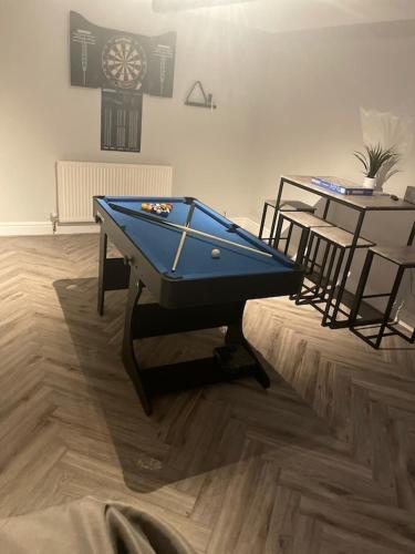 a pool table in the middle of a room with a table at Quirky cottage in the centre of Penrith with a Hot Tub in Penrith
