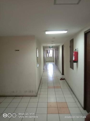 an empty hallway with a fire hydrant in a building at Eastpark Apartment in Jakarta